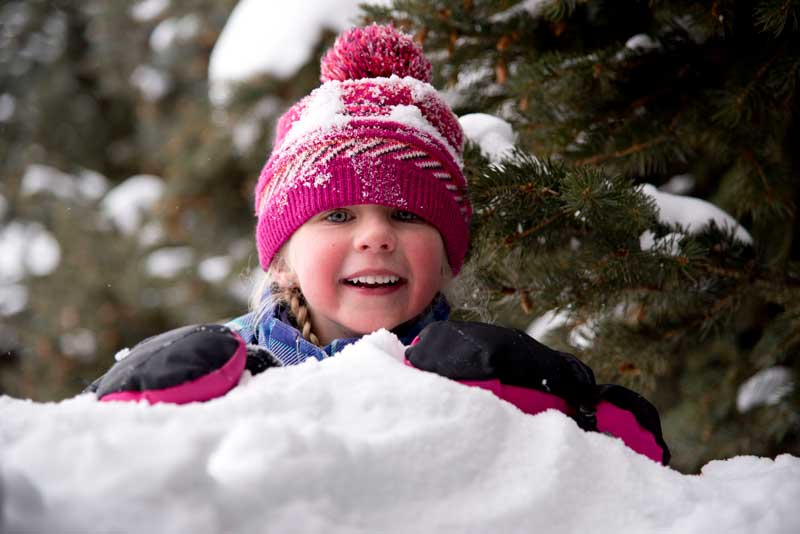 Young girl playing in snow at Latigo Ranch