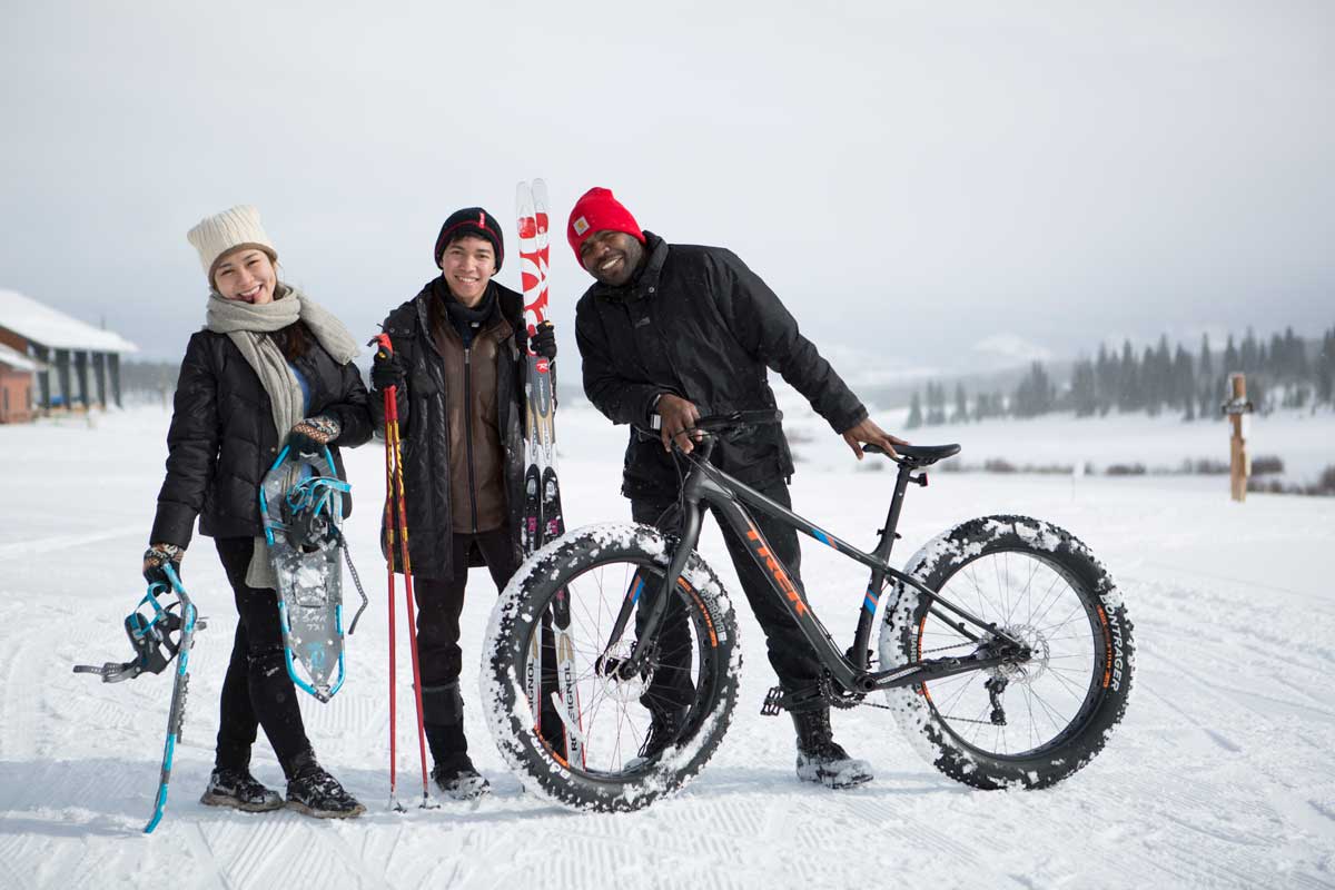 Person with nordic skis, person with snowshoes, and person with a fat tire bike