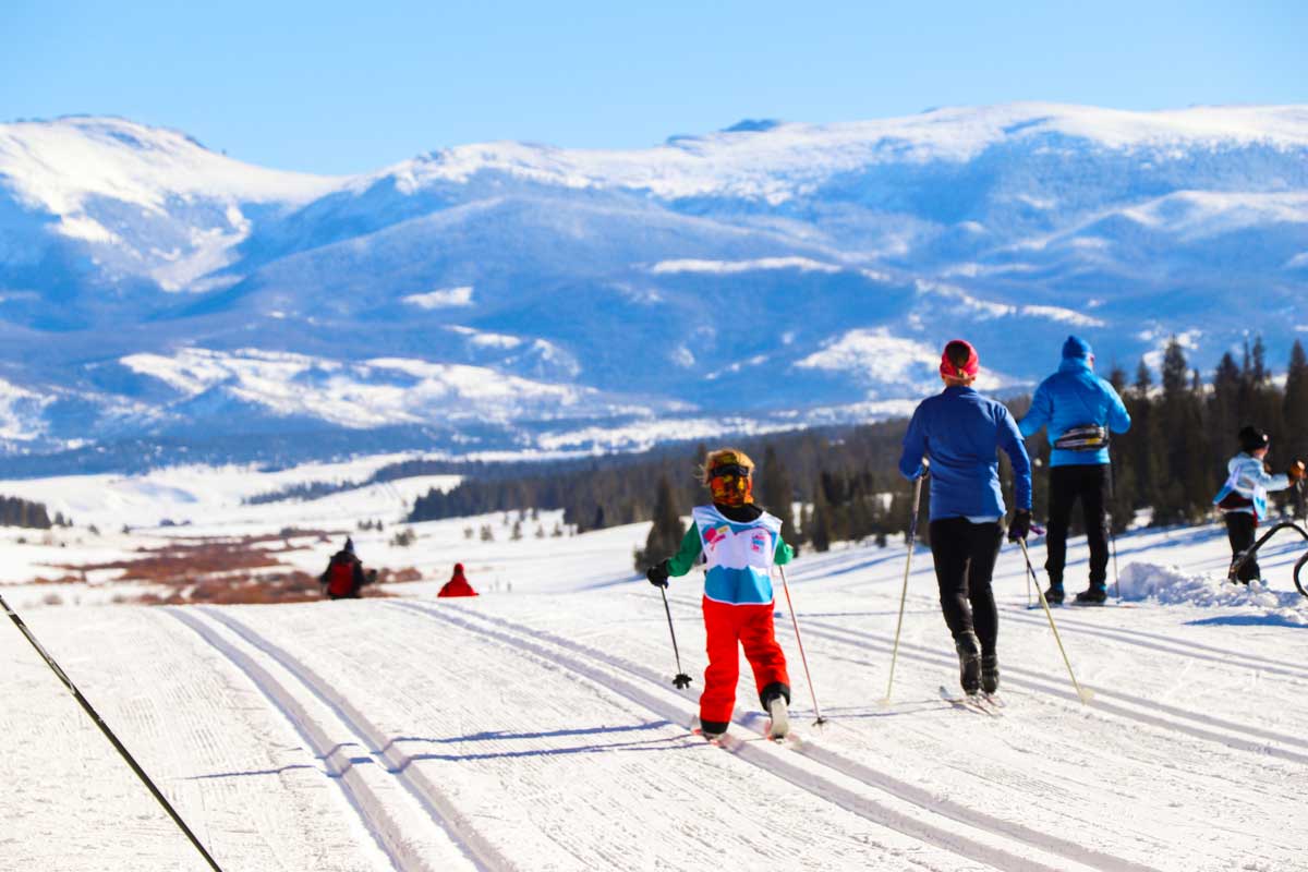 A young boy and his mother taking part in a ski race